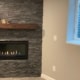 finished basement with stone fireplace and electric insert - South Metro Custom Remodeling basement contractor Edina MN