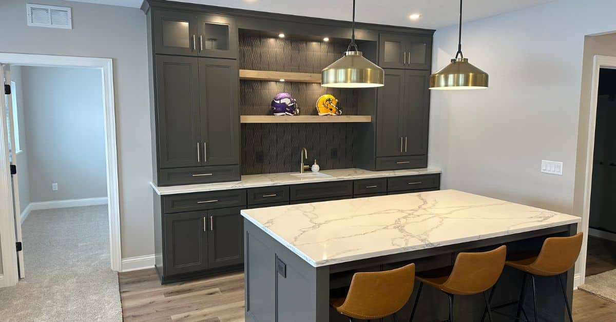 finished basement with wet bar that has dark grey cabinets - South Metro Custom Remodeling basement contractor Prior Lake MN