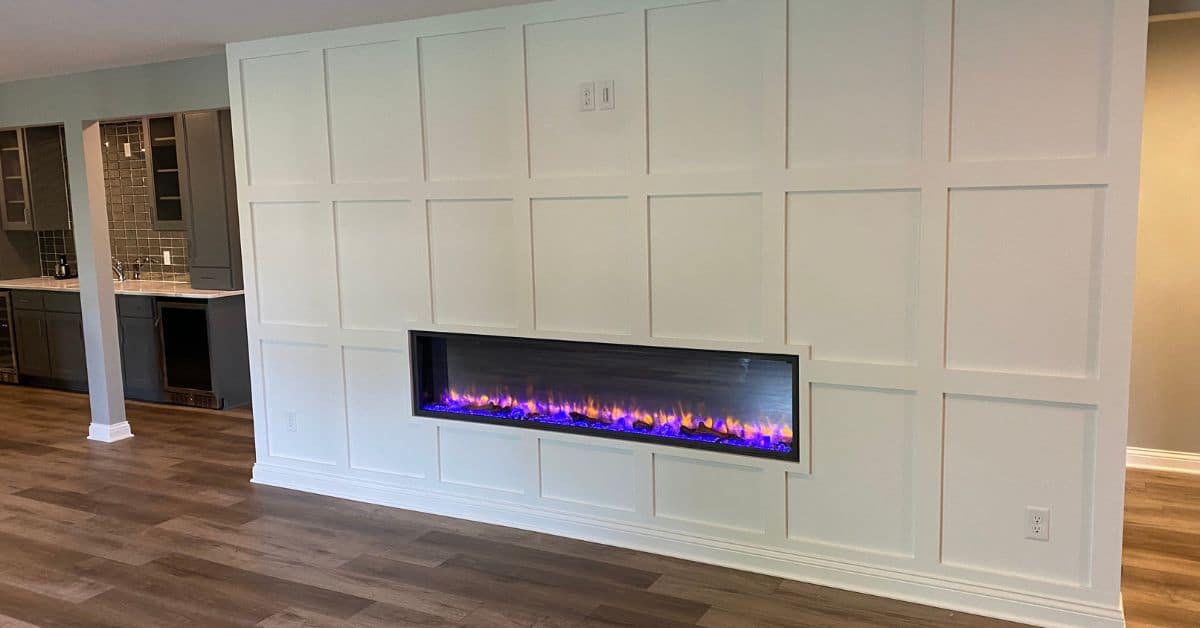 wall mounted electric fireplace with wood work - South Metro Custom Remodeling basement contractor Prior Lake MN