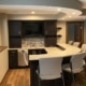 finished basement with full kitchen and peninsula with barstools - South Metro Custom Remodeling basement contractor