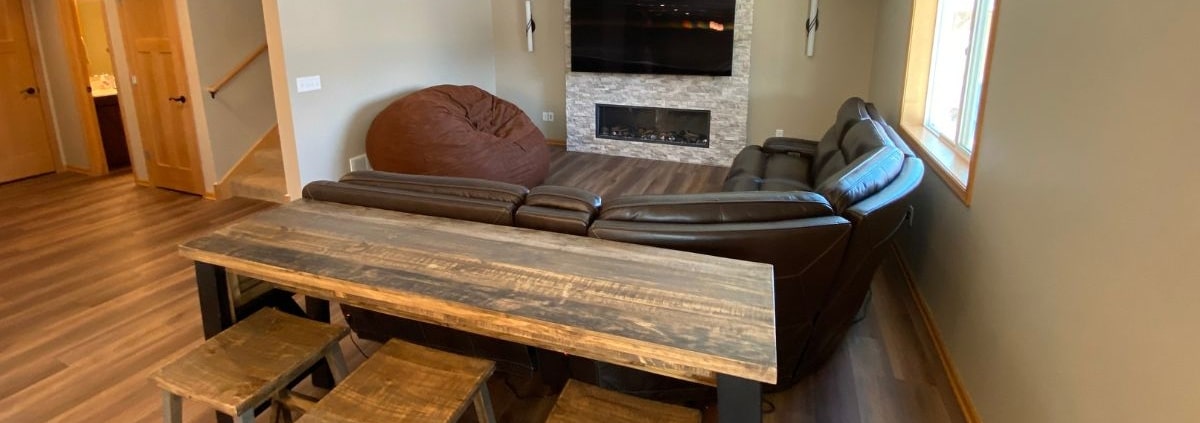 finished basement with a brown leather sectional couch - South Metro Custom Remodeling basement contractor