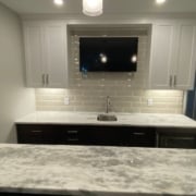 finished basement with a full kitchen with stone countertops - South Metro Custom Remodeling basement contractor