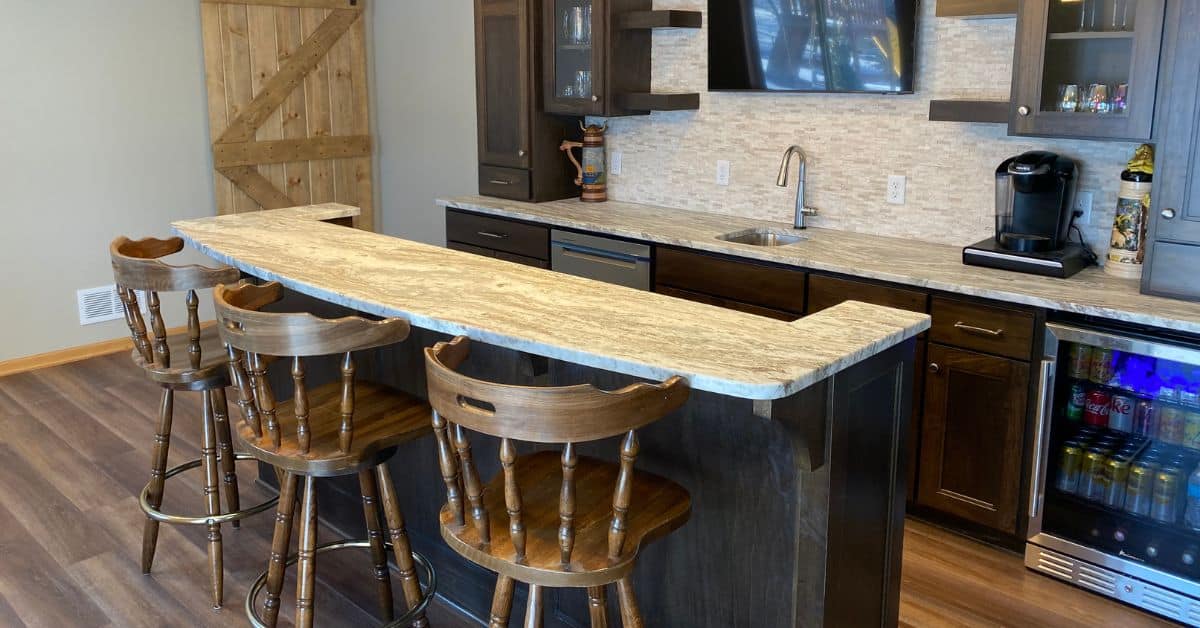 finished basement with dark brown cabinets and light stone counters - South Metro Custom Remodeling basement contractor