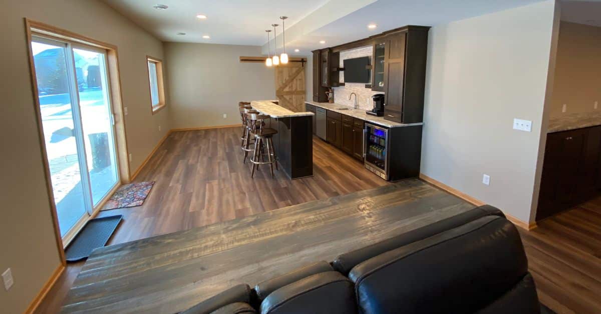 finished basement with a full kitchen and sliding glass doors - South Metro Custom Remodeling basement contractor