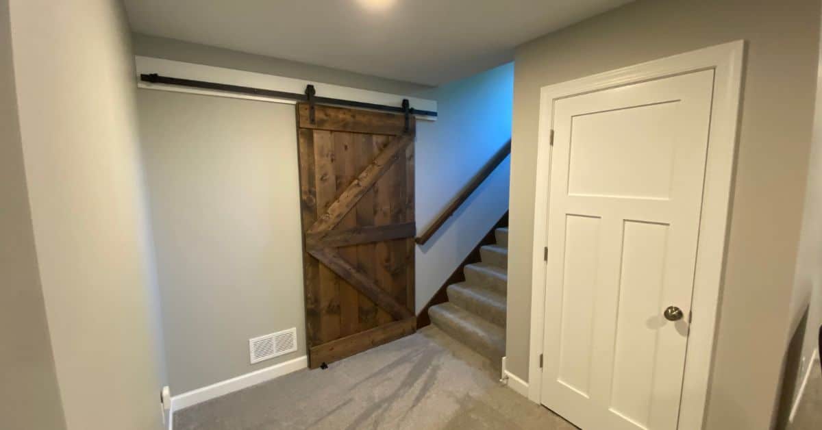 finished basement with new carpet and barn door - South Metro Custom Remodeling basement contractor