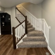 finished basement with carpeted stairs and dark wood floors - South Metro Custom Remodeling custom basement remodeling