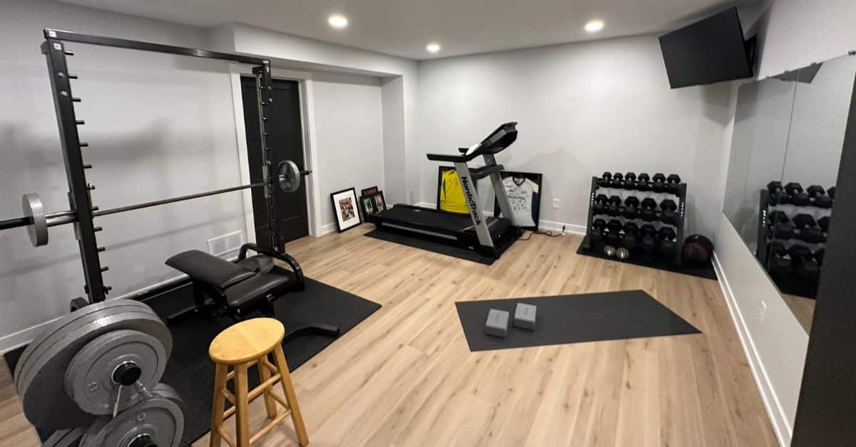 finished basement with light gym equipment - South Metro Custom Remodeling custom basement remodeling