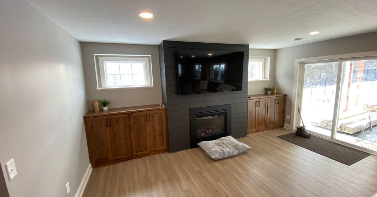 finished basement with custom cabinetry and wall mounted TV - South Metro Custom Remodeling custom basement remodeling