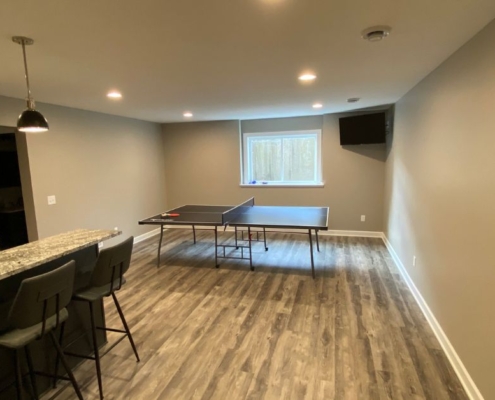 finished basement with ping pong table and large window - South Metro Custom Remodeling custom basement remodel