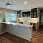 finished basement with a full kitchen and projector screen - South Metro Custom Remodeling custom basement remodel