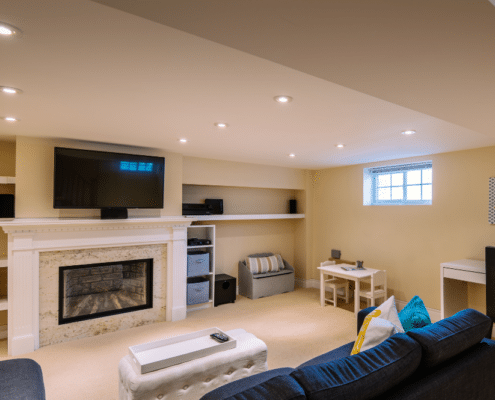 A warm basement showcasing a stylish fireplace remodel, ideal for Minnesota's chilly climate.