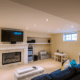 A warm basement showcasing a stylish fireplace remodel, ideal for Minnesota's chilly climate.